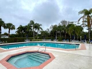 view of swimming pool featuring a community hot tub