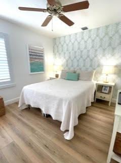 bedroom featuring ceiling fan and wood-type flooring