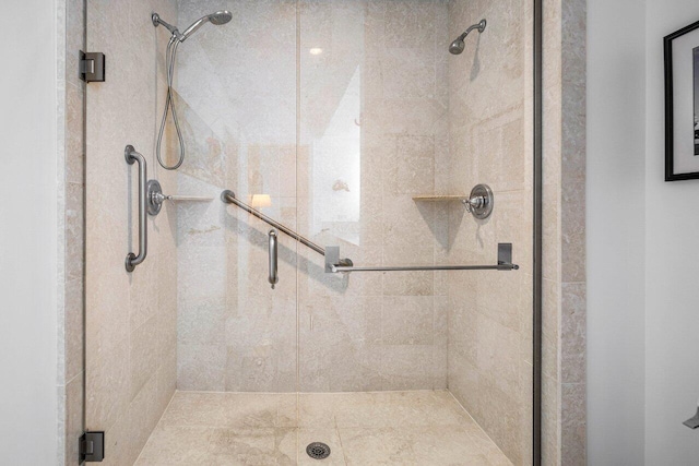 bathroom featuring a shower with door