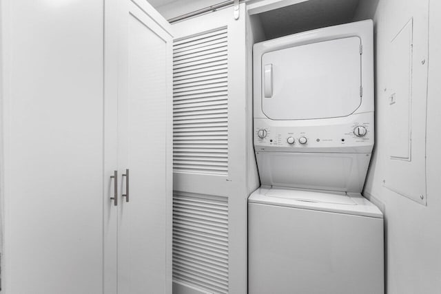 laundry area with stacked washer and dryer