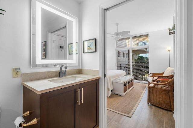 bathroom with ceiling fan, wood-type flooring, and vanity