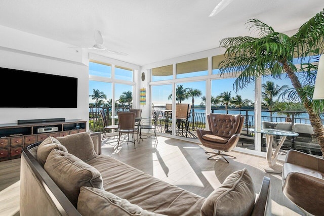 interior space with ceiling fan and a water view