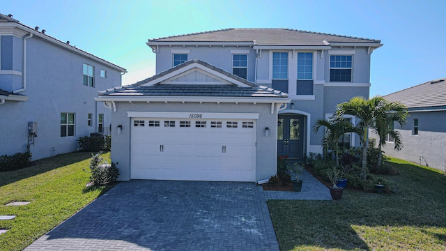 view of front facade with a front yard and a garage