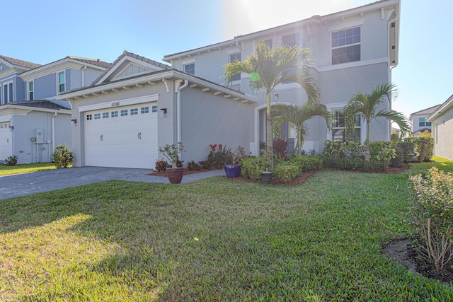 view of front of house with a garage and a front yard