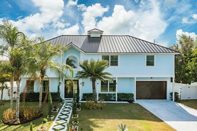 mediterranean / spanish home featuring a garage and a lawn