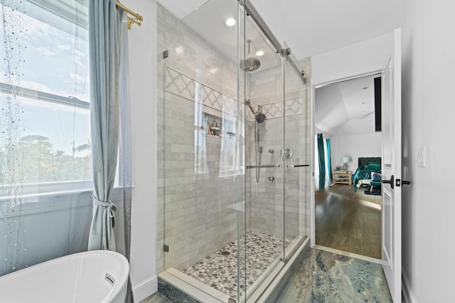 bathroom featuring separate shower and tub