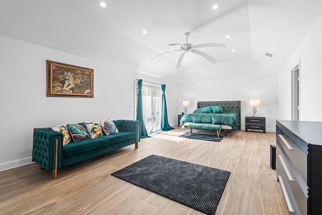 living room with light hardwood / wood-style flooring, vaulted ceiling, and ceiling fan