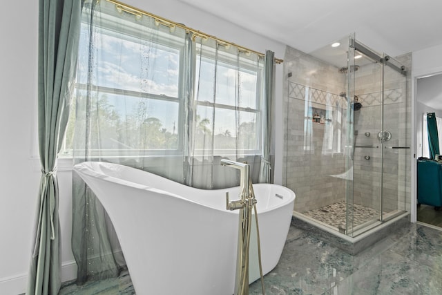 bathroom featuring shower with separate bathtub