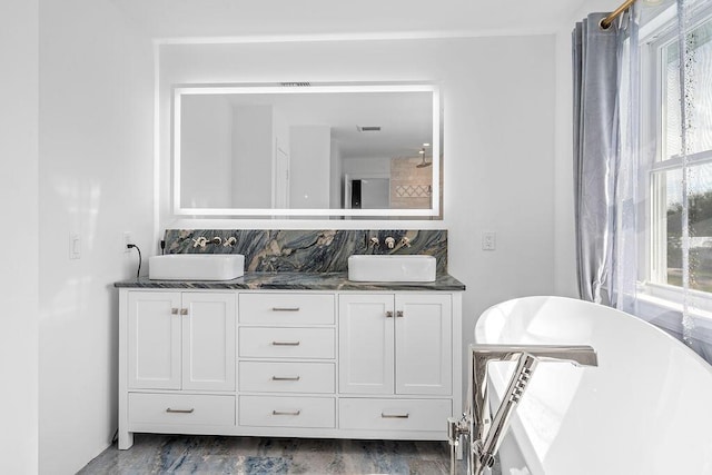 bathroom featuring vanity, hardwood / wood-style flooring, and tasteful backsplash