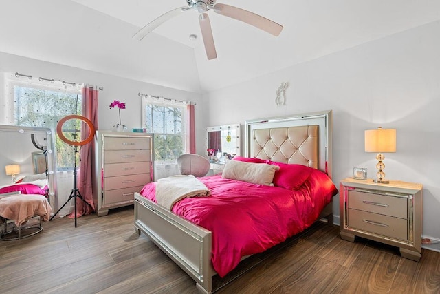 bedroom with vaulted ceiling, dark wood-type flooring, and ceiling fan