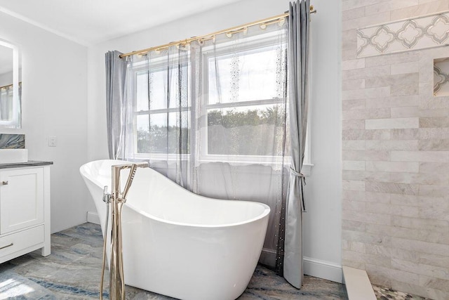 bathroom featuring vanity and a bath