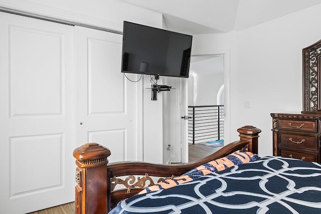 bedroom with wood-type flooring and a closet