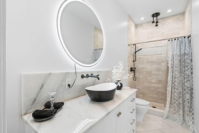 bathroom with toilet, vanity, tile patterned floors, and walk in shower