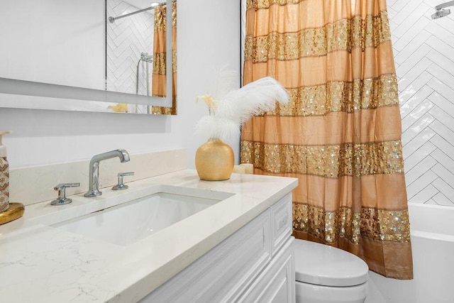 details with vanity, shower / bath combo, and toilet