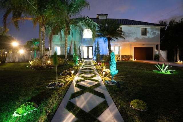 view of front of home featuring a yard and a garage