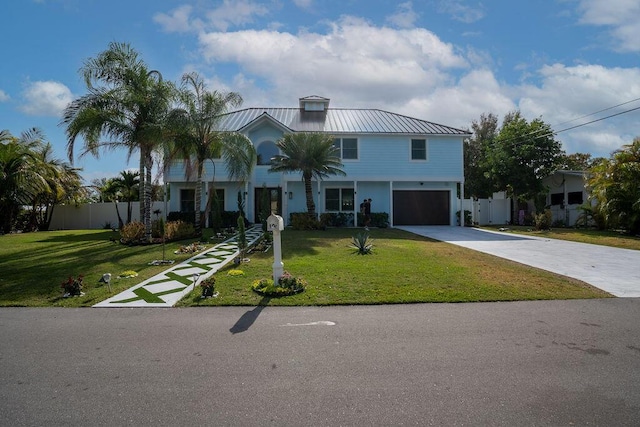 view of front of house with a garage and a front lawn