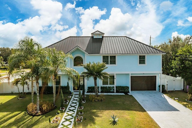 view of front of home featuring a garage and a front lawn