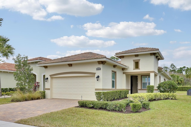 mediterranean / spanish house with a garage and a front lawn