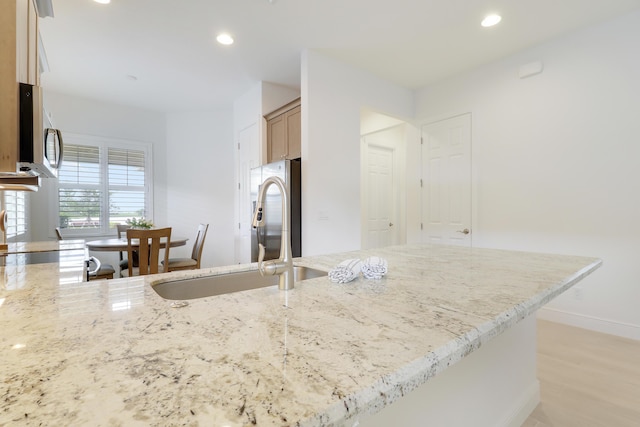 11263 SW Visconti Way, Port Saint Lucie, FL 34986 - kitchen featuring appliances with stainless steel finishes, recessed lighting, light stone countertops, and light wood finished floors