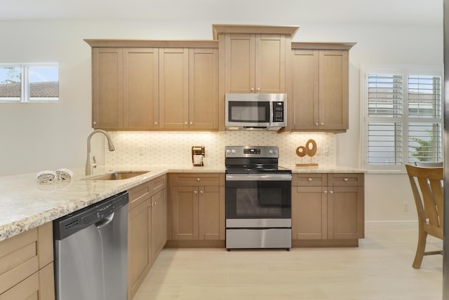 11263 SW Visconti Way, Port Saint Lucie, FL 34986 - kitchen with stainless steel appliances, backsplash, and light stone counters