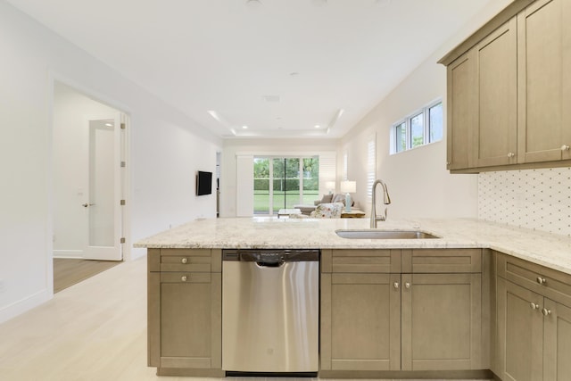 11263 SW Visconti Way, Port Saint Lucie, FL 34986 - kitchen with dishwasher, a peninsula, light wood-style floors, and light stone countertops