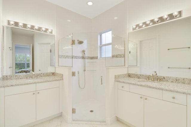 bathroom with vanity and a shower with door