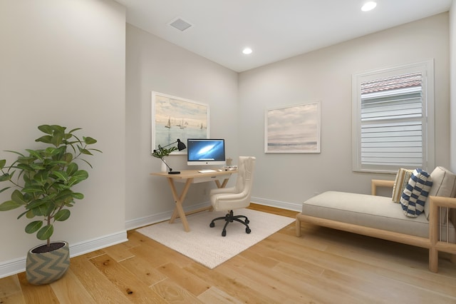 office with light wood-type flooring