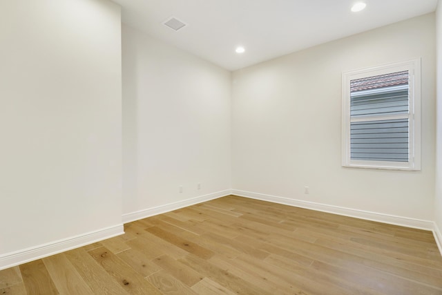 empty room with light hardwood / wood-style flooring