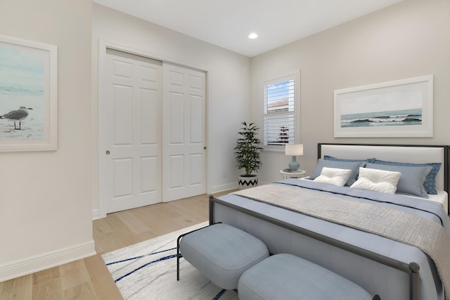 bedroom featuring light hardwood / wood-style floors and a closet