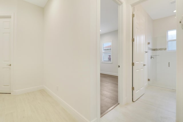 11263 SW Visconti Way, Port Saint Lucie, FL 34986 - hallway featuring healthy amount of natural light and light wood finished floors