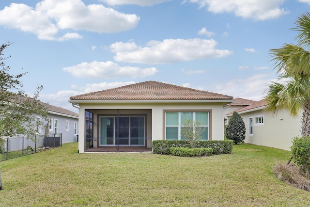 back of property featuring a yard and a sunroom