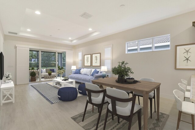 11263 SW Visconti Way, Port Saint Lucie, FL 34986 - dining area featuring a tray ceiling, recessed lighting, and light wood-style flooring