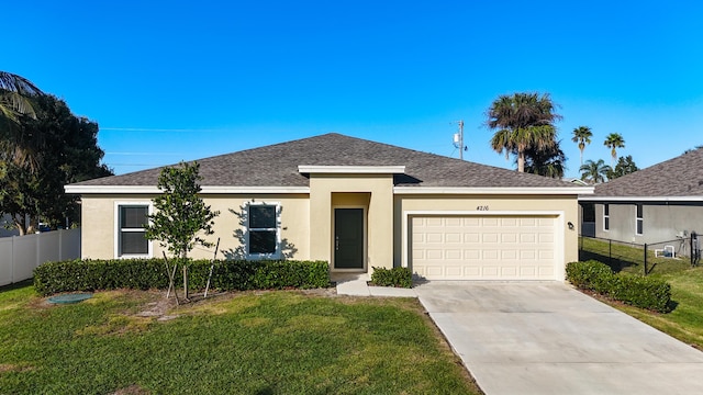 view of front of home featuring a garage and a front lawn