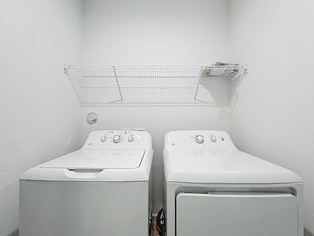 laundry room with washing machine and clothes dryer