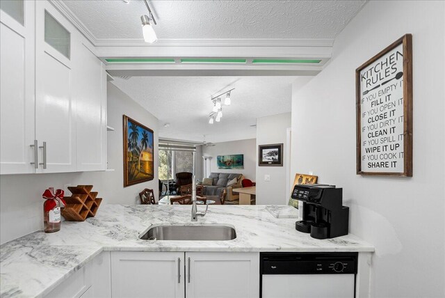 1806 SE Hideaway Cir Unit 1806, Port Saint Lucie, FL 34952 - kitchen with white dishwasher, a textured ceiling, white cabinets, a peninsula, and rail lighting