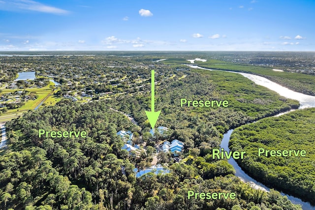 drone / aerial view featuring a forest view