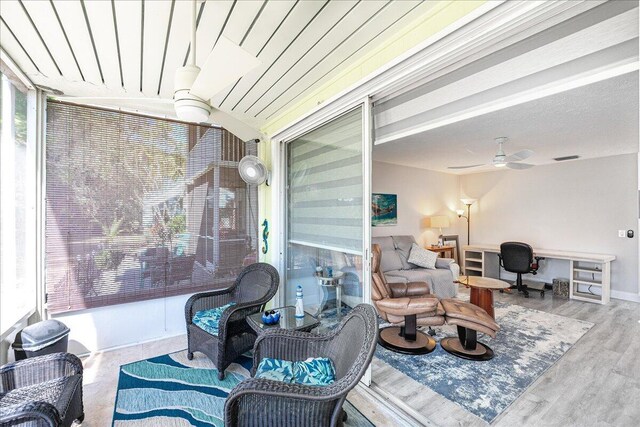 living room with a textured ceiling, a fireplace, wood finished floors, and visible vents