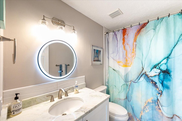 bathroom with visible vents, toilet, curtained shower, a textured ceiling, and vanity