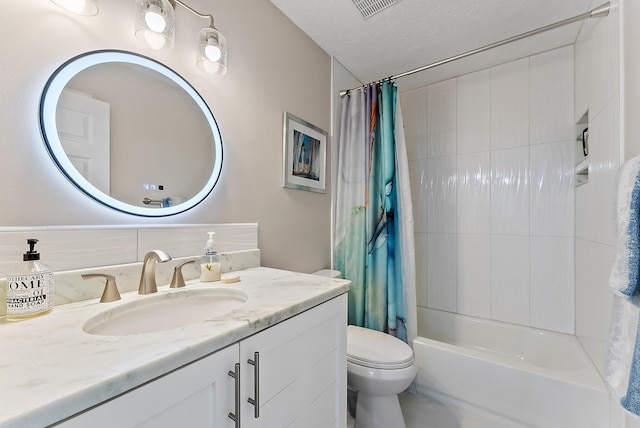 full bathroom featuring visible vents, toilet, shower / bath combo with shower curtain, a textured ceiling, and vanity