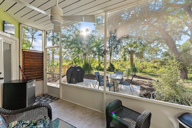 sunroom / solarium with plenty of natural light and ceiling fan