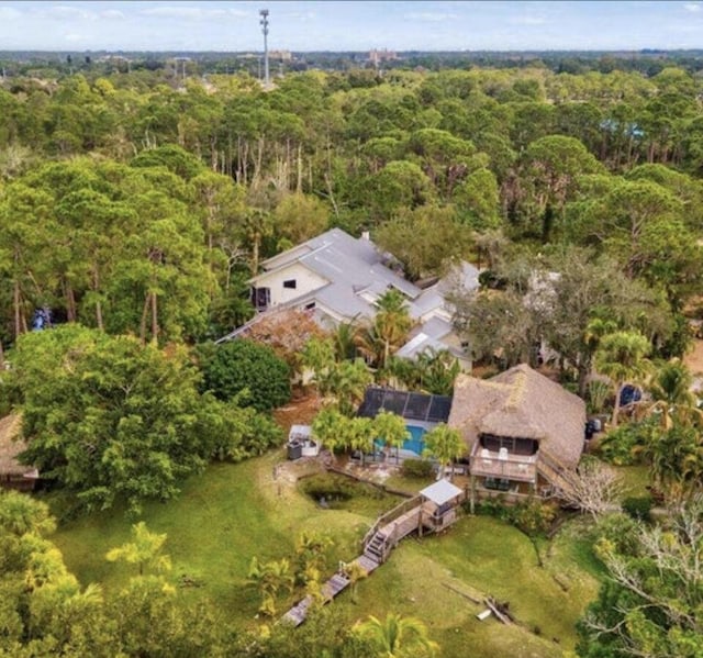 drone / aerial view featuring a wooded view