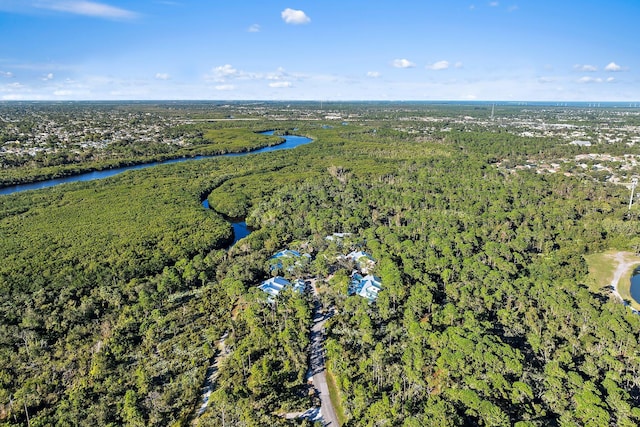 birds eye view of property featuring a water view and a view of trees