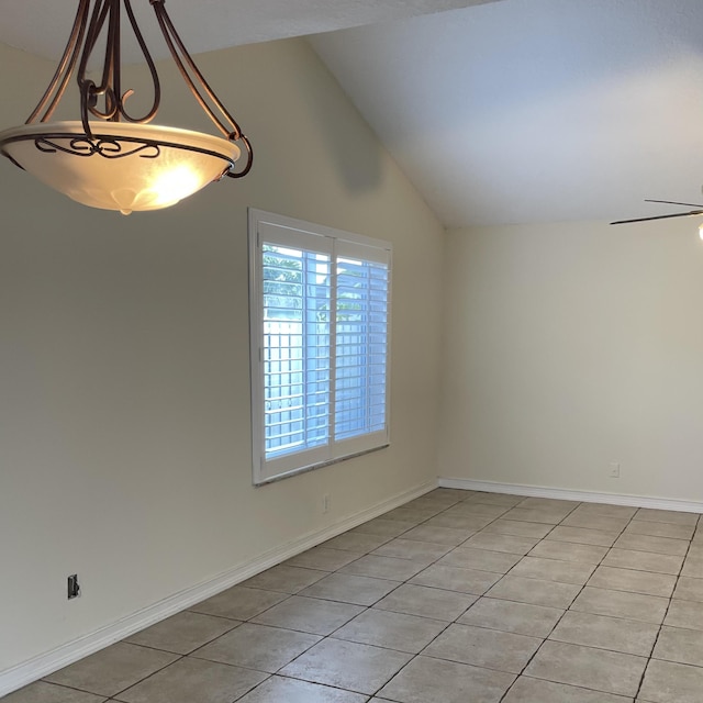 empty room featuring lofted ceiling, light tile patterned floors, and ceiling fan