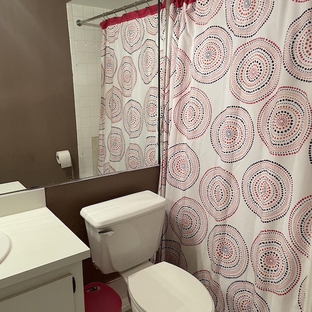 bathroom featuring vanity, toilet, and a shower with shower curtain