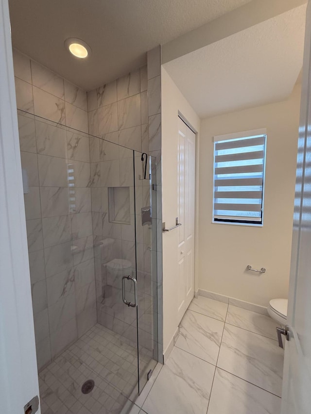 bathroom featuring walk in shower and toilet