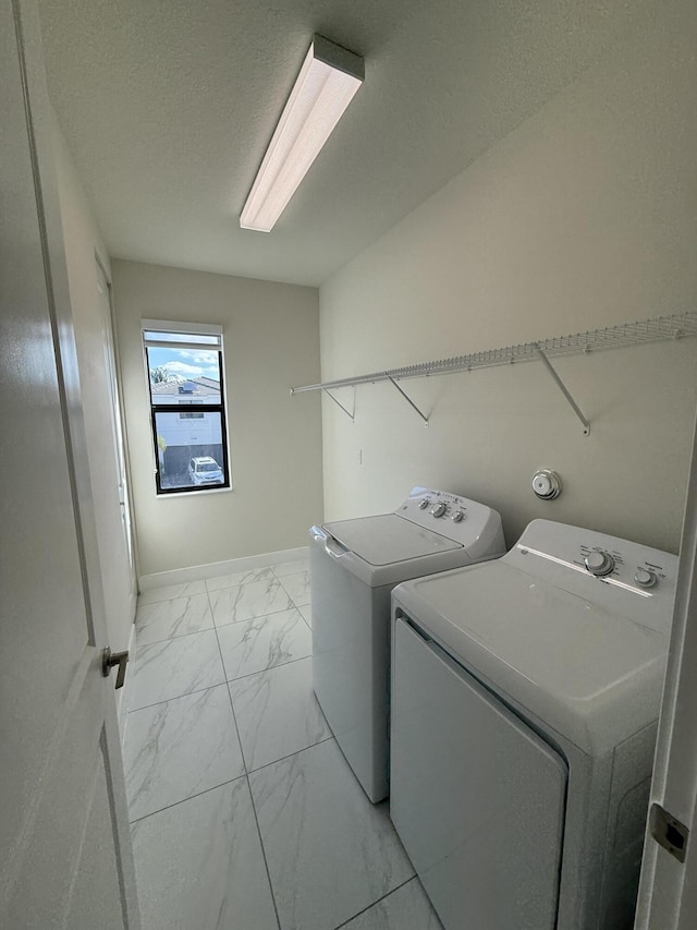 washroom with washing machine and clothes dryer