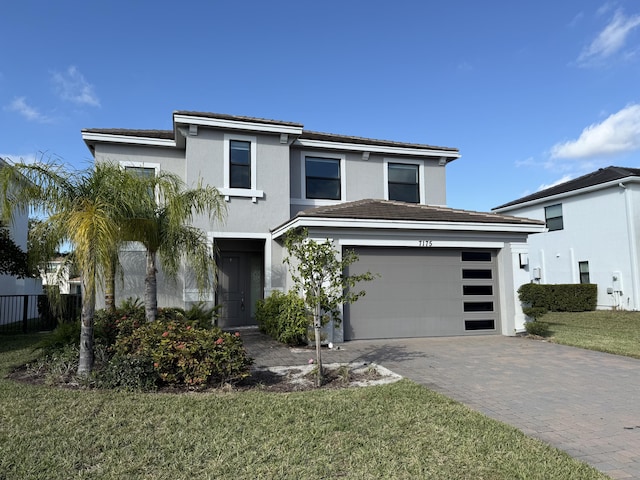 view of front of house with a garage and a front yard