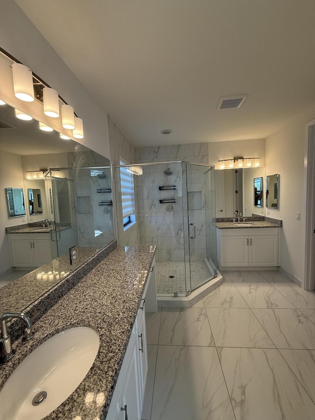 bathroom featuring vanity and an enclosed shower