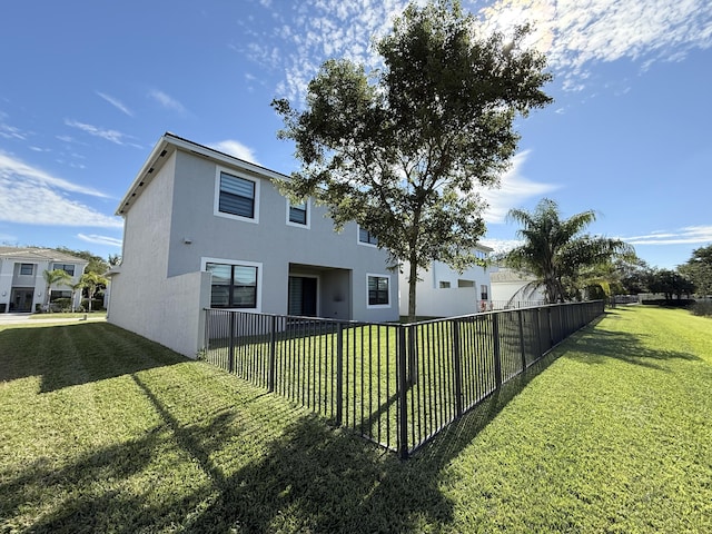 view of side of home with a lawn