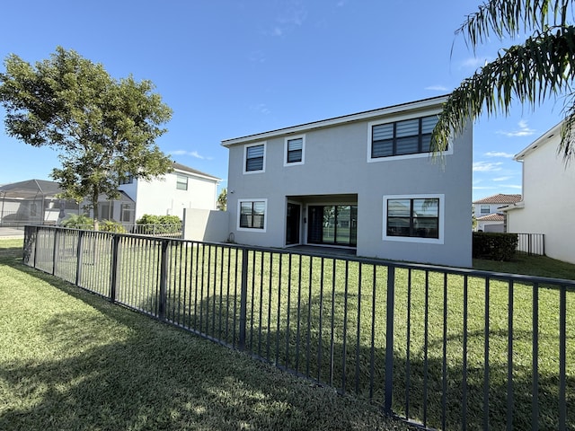 rear view of property featuring a yard